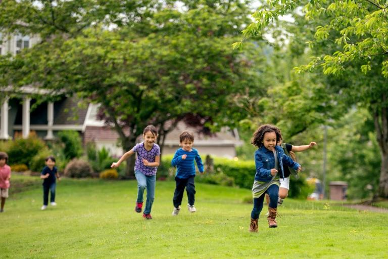 Picture of children running on grass in a park
