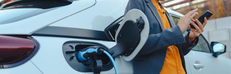 Picture of someone plugging in their electric car charger into their car